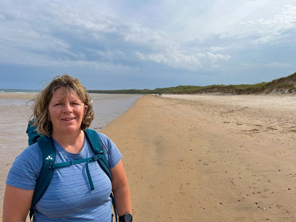 Anny hiking on the beach